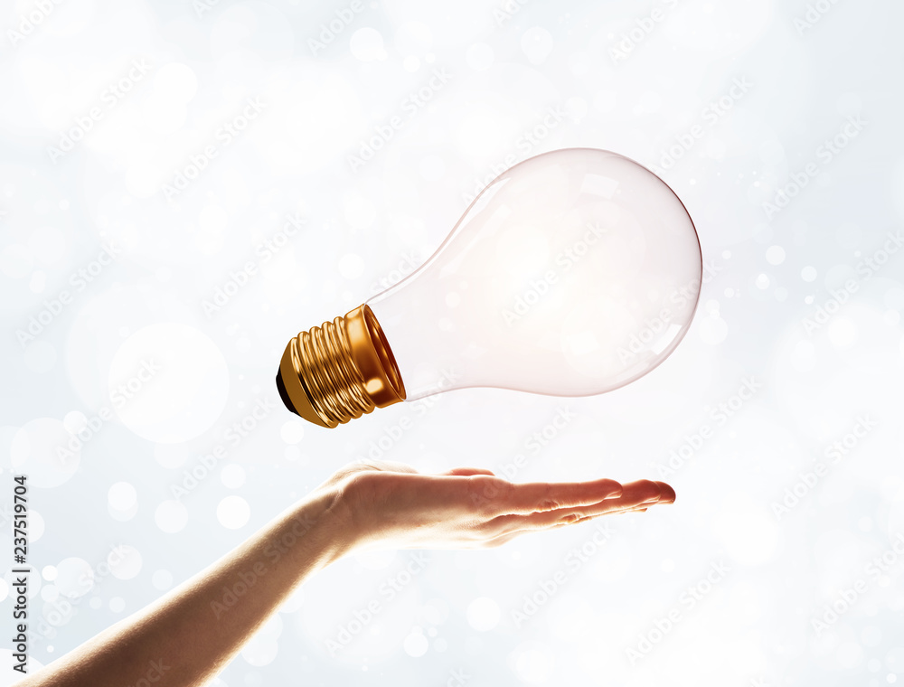 Bring your new idea presented by bulb in man hand