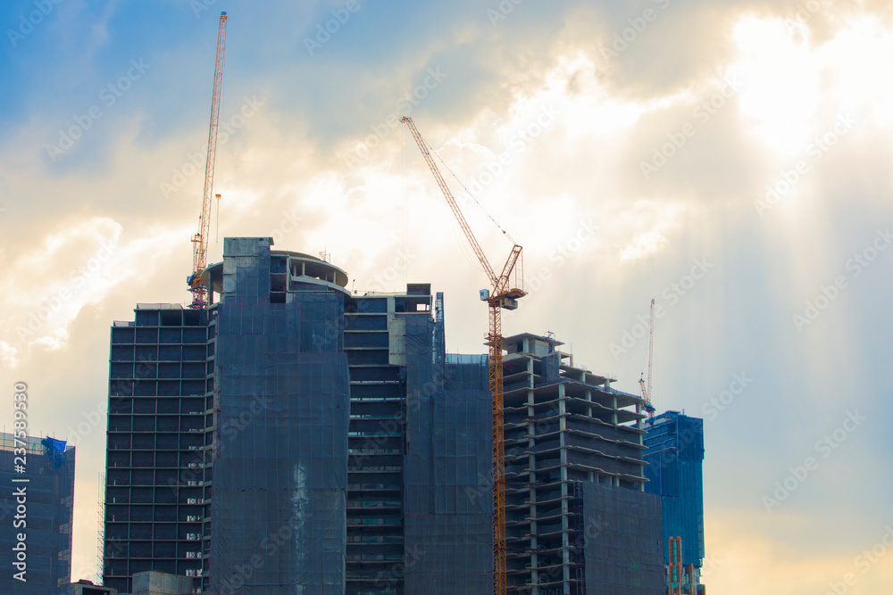 Crane on the construction site is a condominium, beautiful sky background.