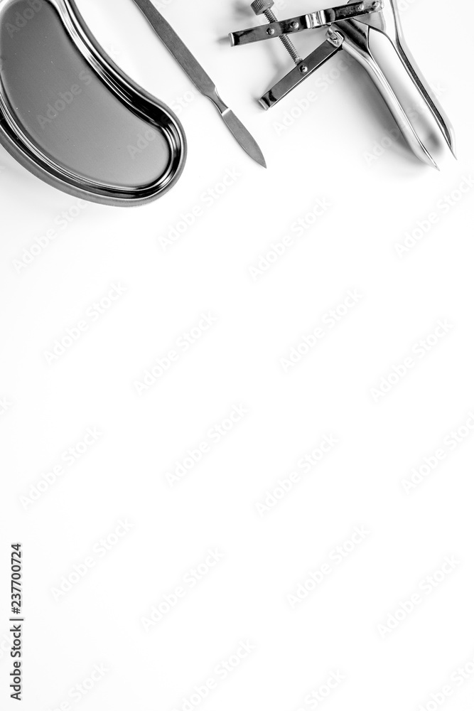 instruments of gynecologist on white background top view