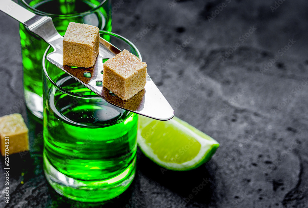 green shots with sugar and lime on table background