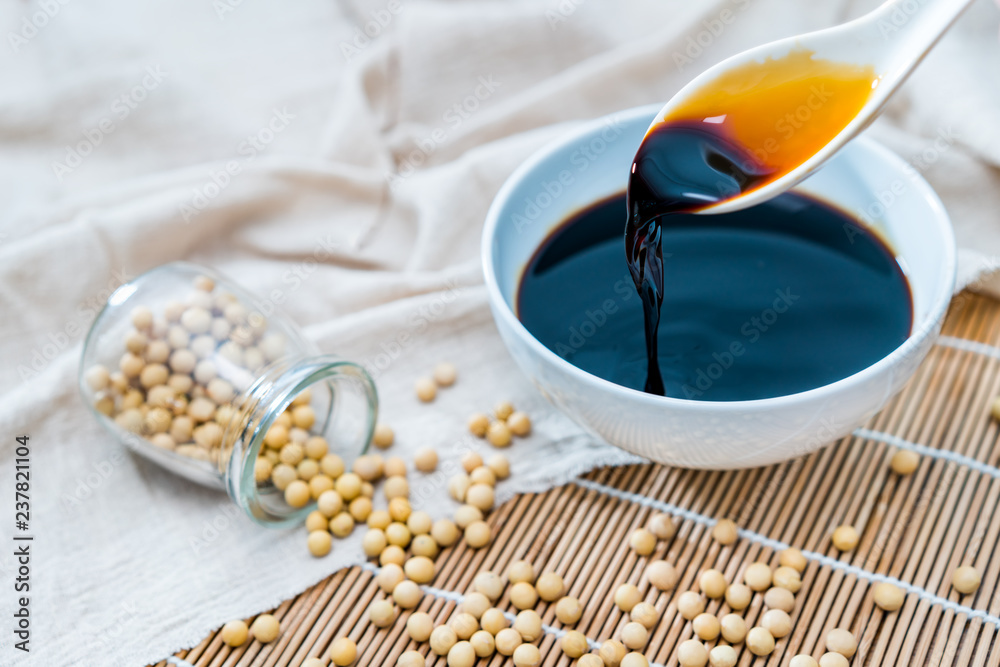 A bowl of soy sauce and sprinkled soybeans	