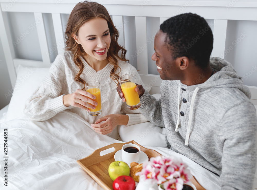 happy couple with breakfast in bed on valentines day