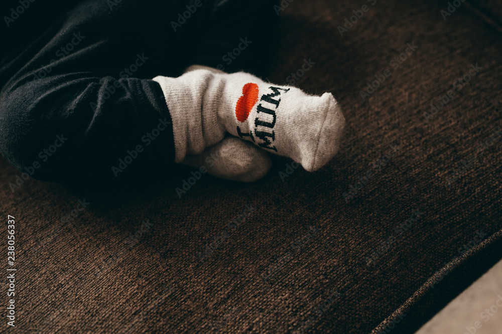 Close up of legs of a baby  wearing socks