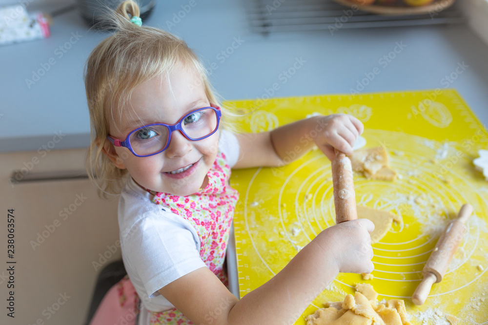 可爱的小女孩拿着大头针准备圣诞饼干