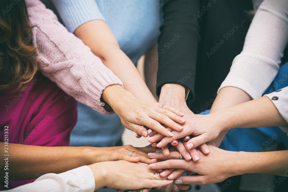 Group of women in the office at the seminar together discuss topics of interest hands close up