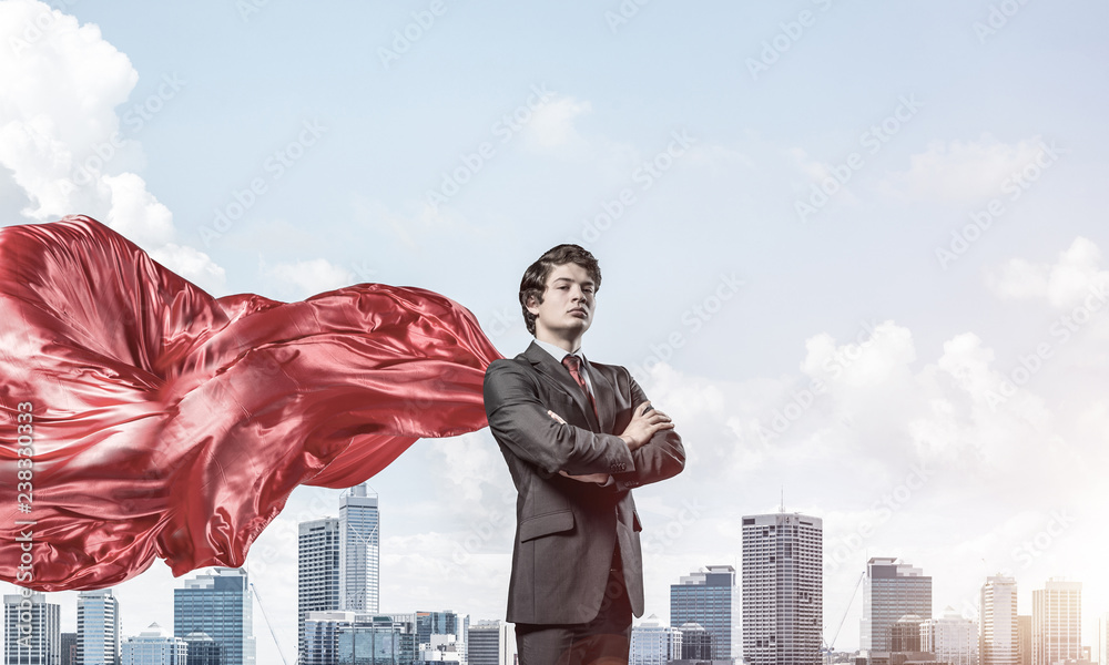 Concept of power and sucess with businessman superhero in big ci