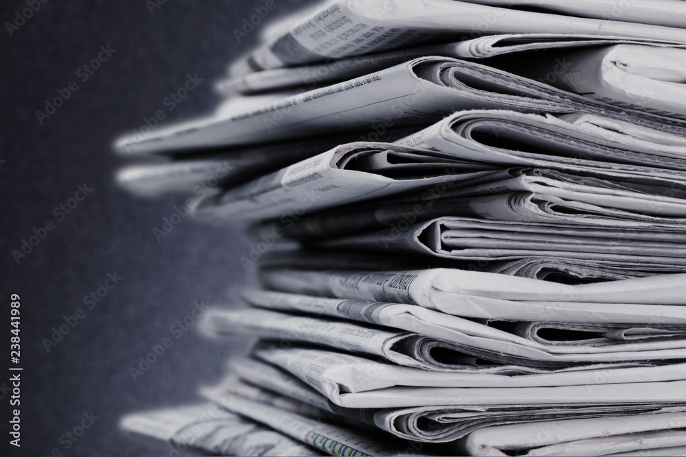 Pile of newspapers on white background