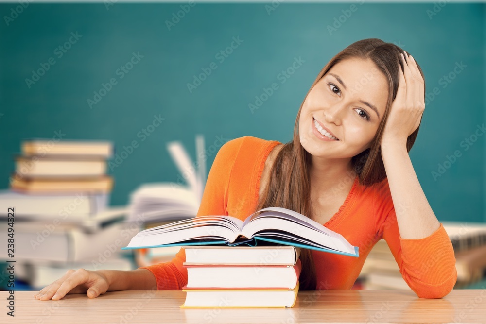 Young female student reading books