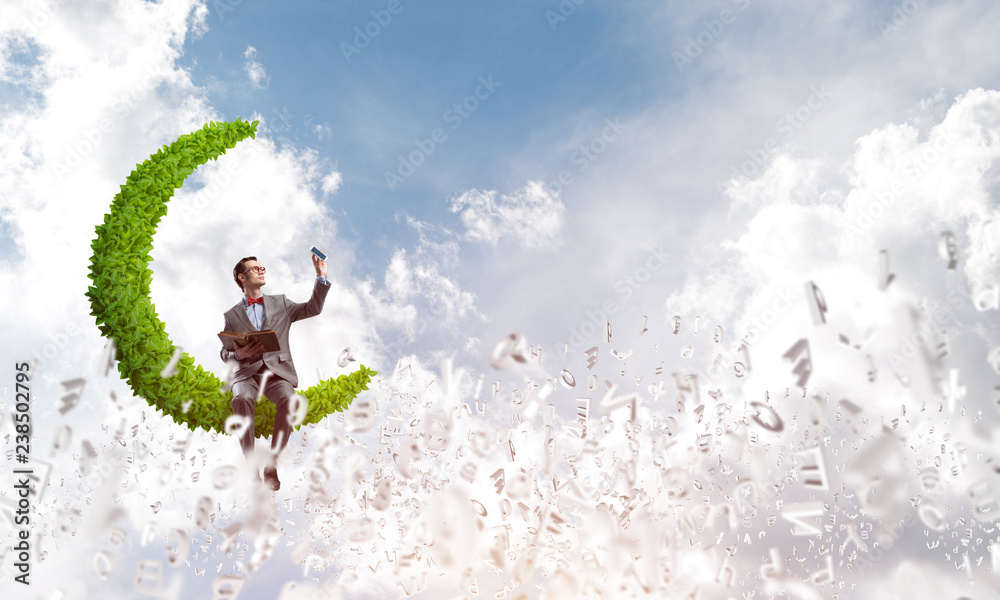 Young businessman or student studying the science and symbols fly around