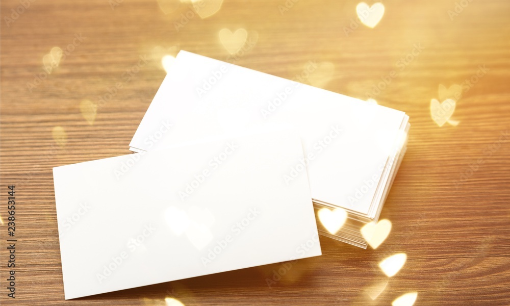 Blank white envelopes pile on wooden background