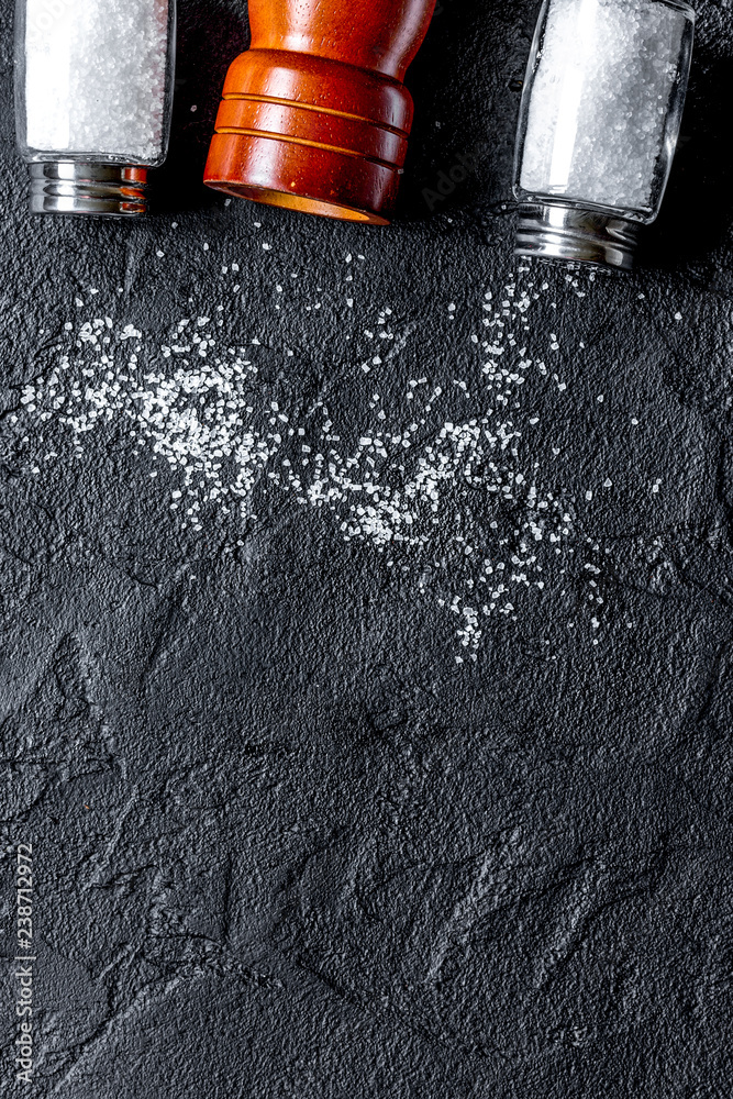 Cooking set with salt and saltcellar on dark background top view