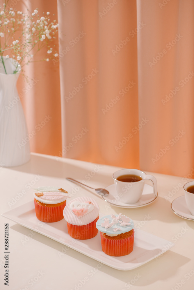 Cupcakes decorated with fondant. Valentine sweet love cupcake on table on light background