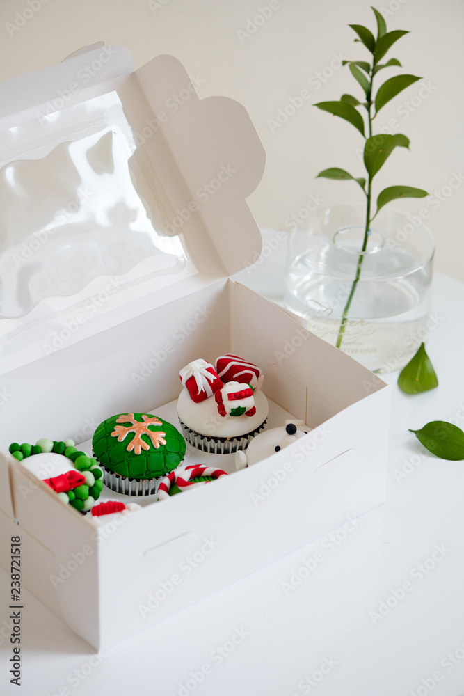 Seasonal festive christmas mini dessert cupcakes in traditional red green decorative symbols element