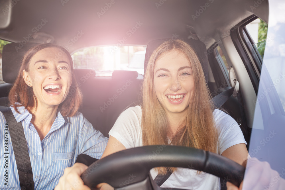 Girl and her mother having fun during road trip