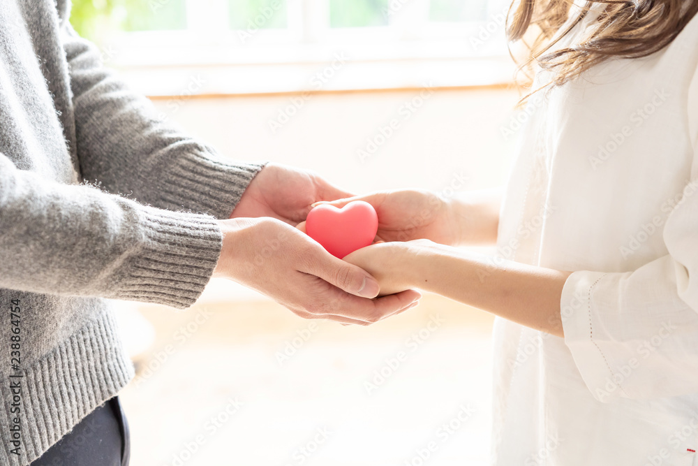 young asian woman holding heart symbol