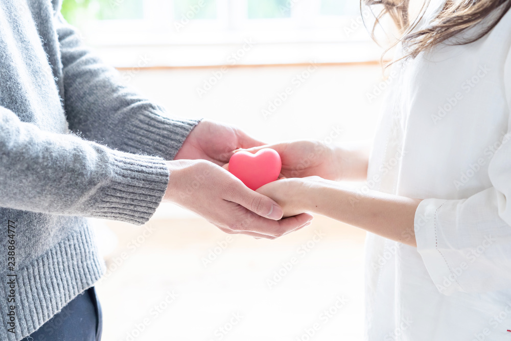 young asian woman holding heart symbol