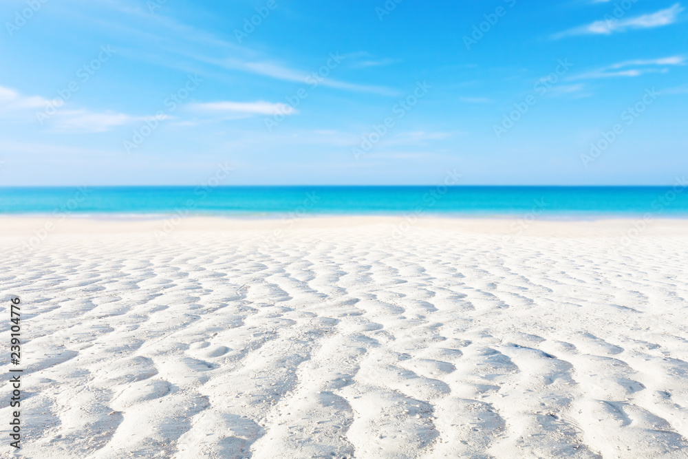 White sand curve or tropical sandy beach with blurry blue ocean and blue sky background image for na