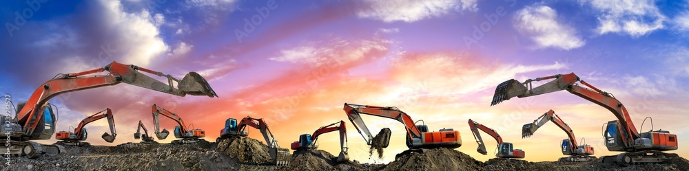 Many excavators work on construction site at sunset,panoramic view