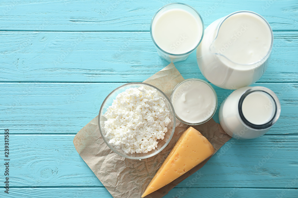 Different milk products on color wooden table