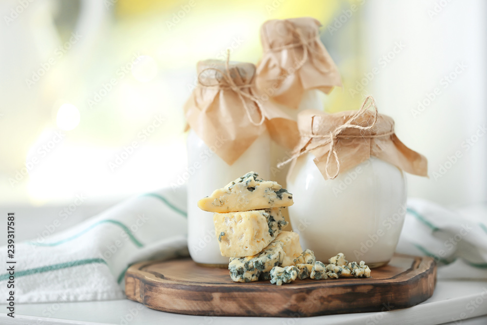 Different milk products on wooden board