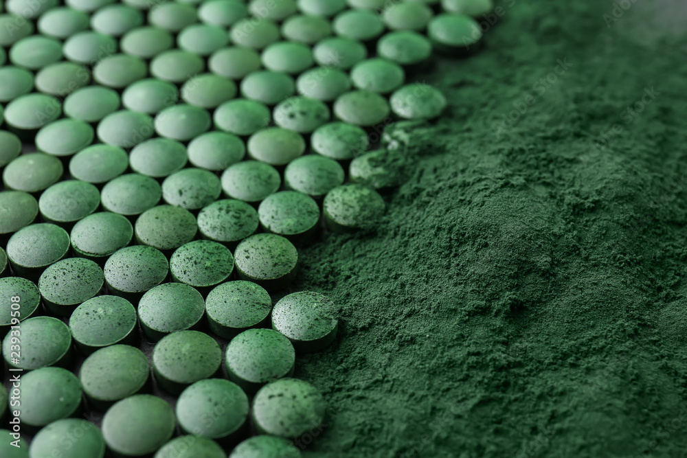 Spirulina tablets with powder, closeup