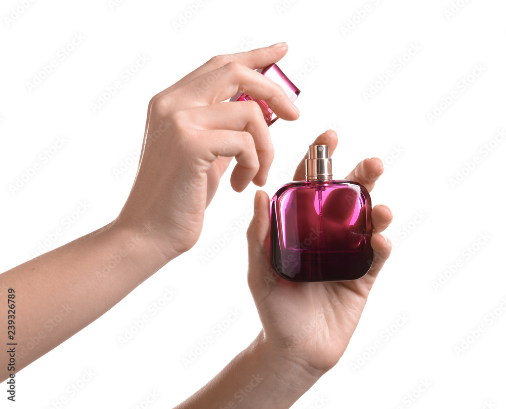 Woman holding bottle of perfume on white background