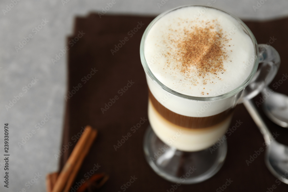 Glass cup of tasty aromatic latte on table