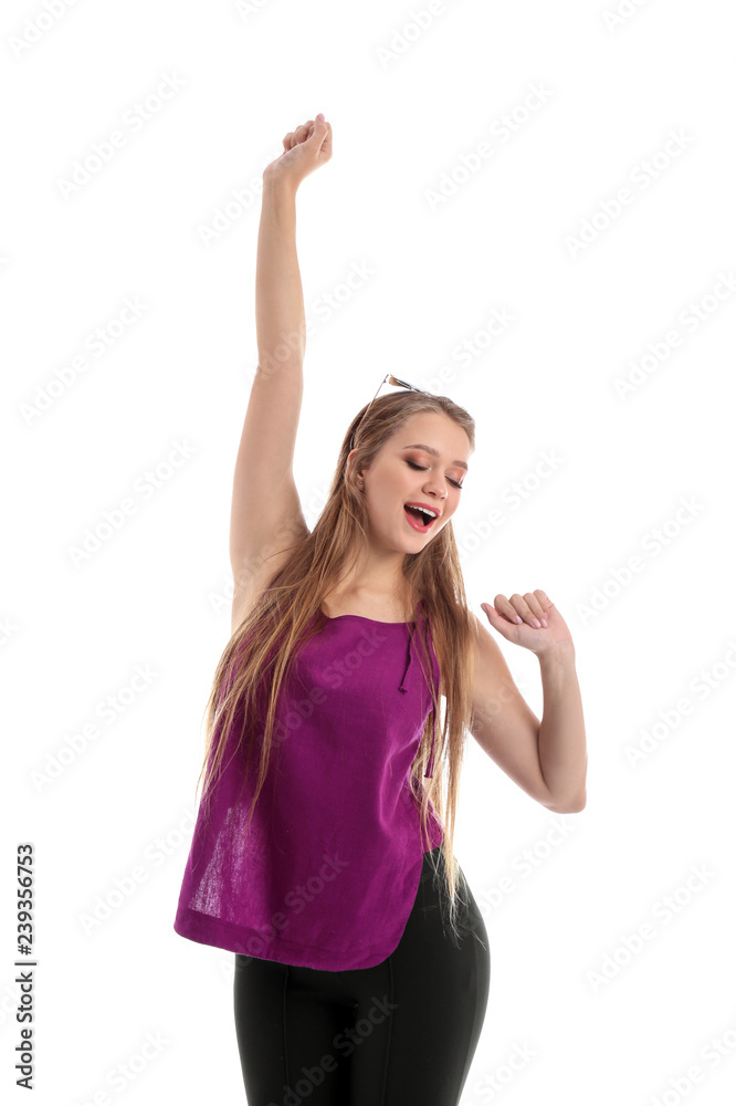 Beautiful young woman dancing on white background