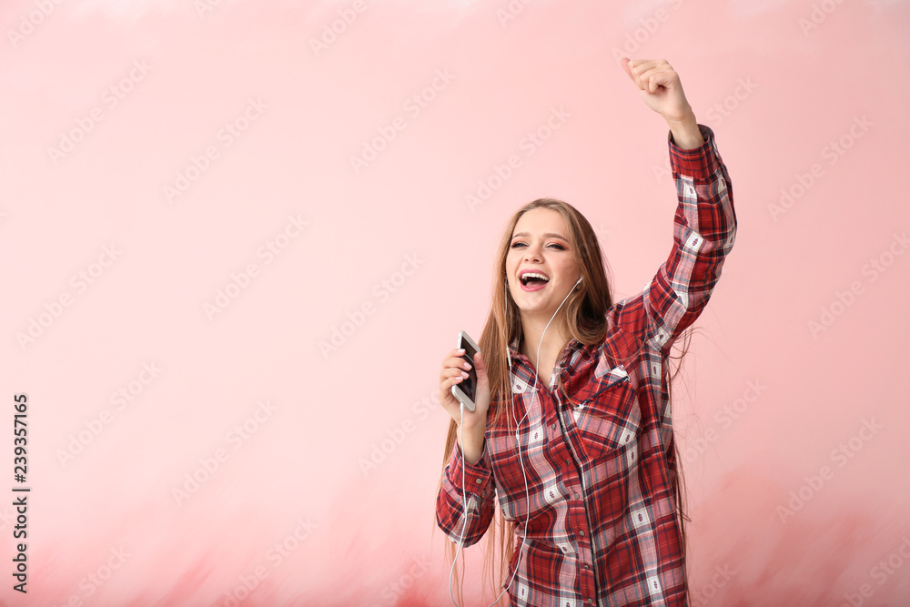 Beautiful young woman dancing on color background