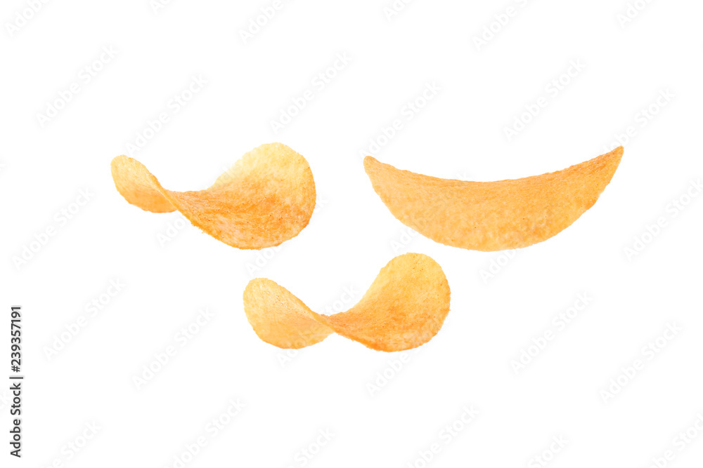 Tasty crispy potato chips on white background