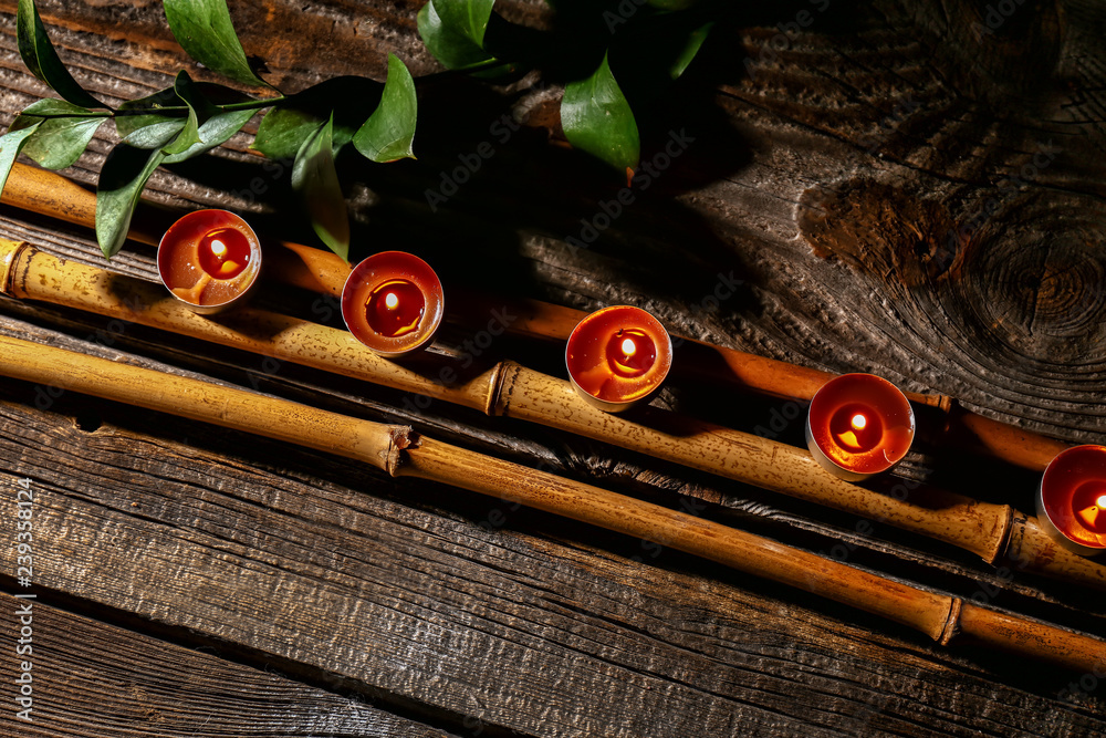 Beautiful composition with burning candles on wooden table