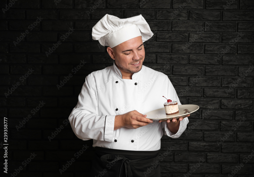 Male chef with tasty dessert on dark background