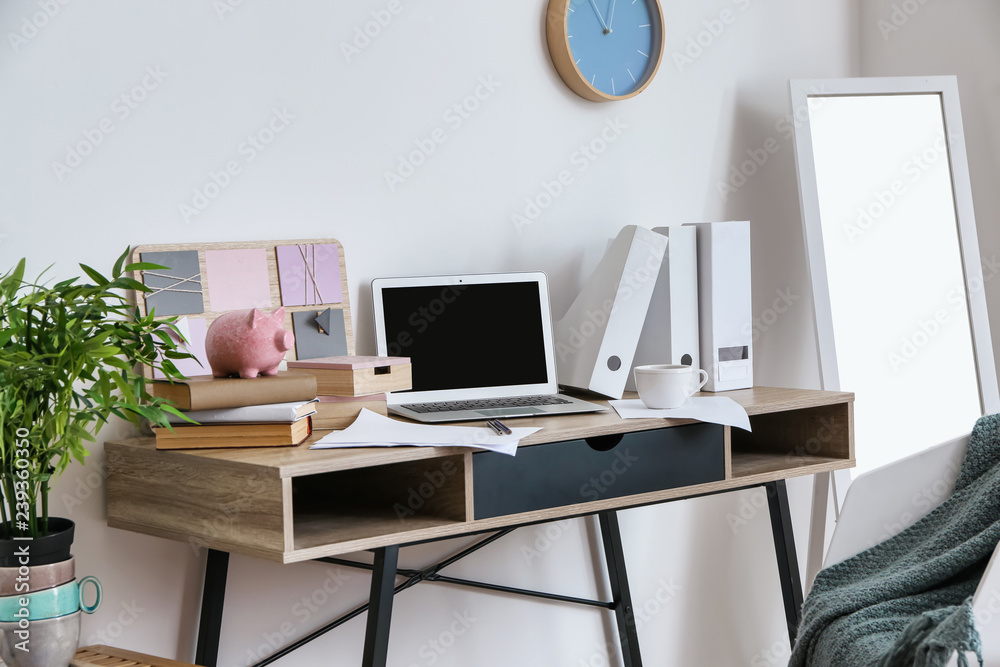 Comfortable workplace with modern laptop in room