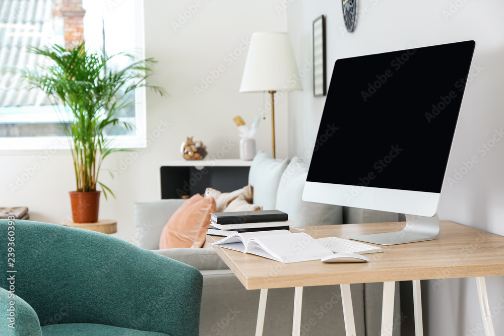 Stylish workplace with modern computer in room