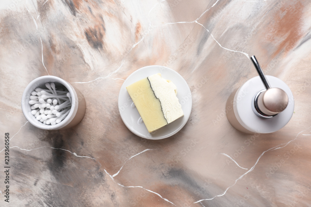 Soap and cotton swabs on table