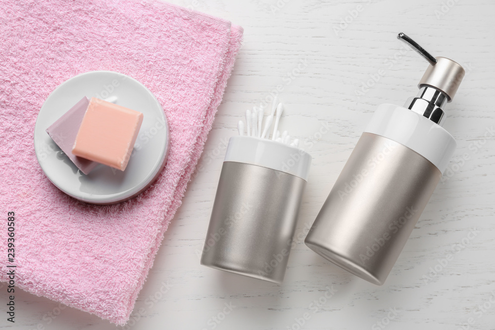 Soap, towel and cotton swabs on white table