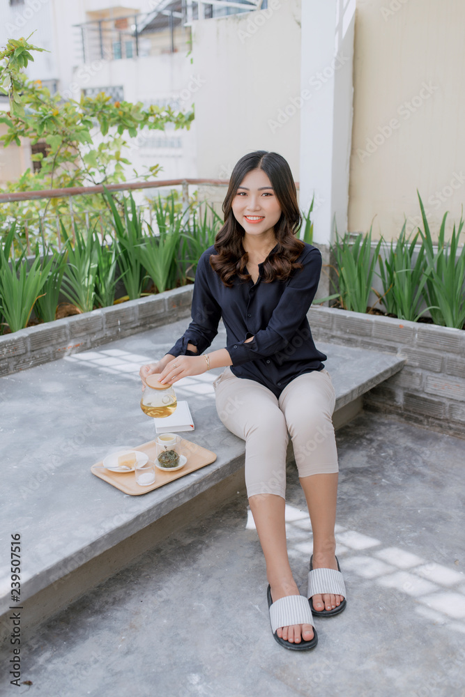 Young asian woman enjoying her comfortable terrace