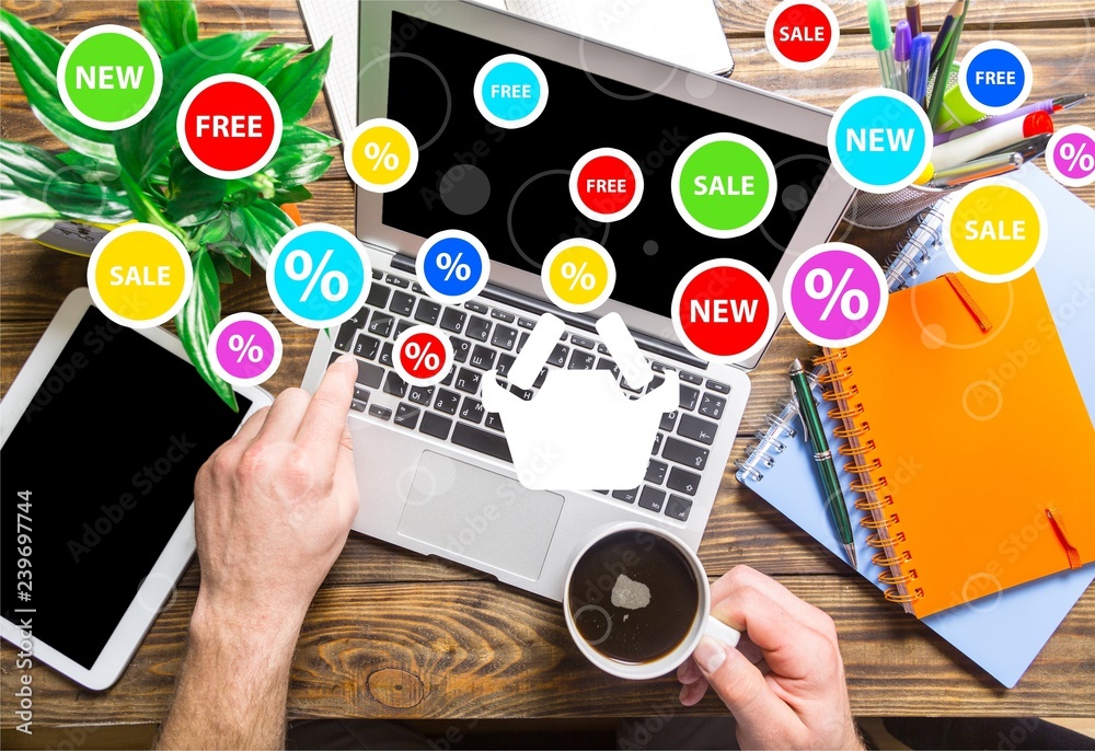 Male hands using laptop, drinking coffee, top view on working