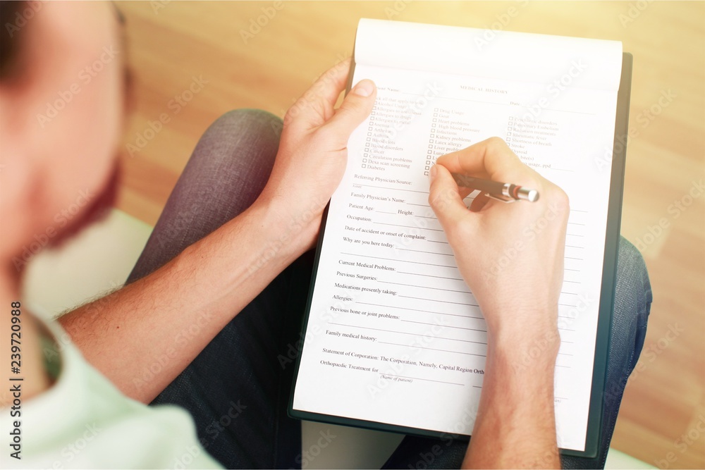 Hand writing in clipboard form psychologist filling clipboard