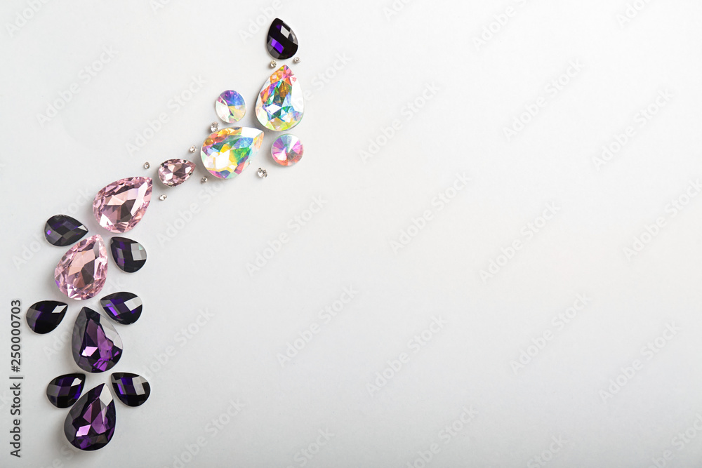 Composition with precious stones for jewellery on white background