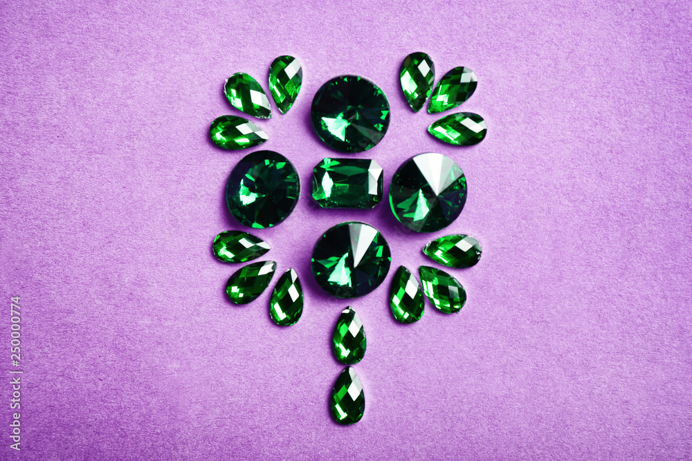 Composition with precious stones for jewellery on color background