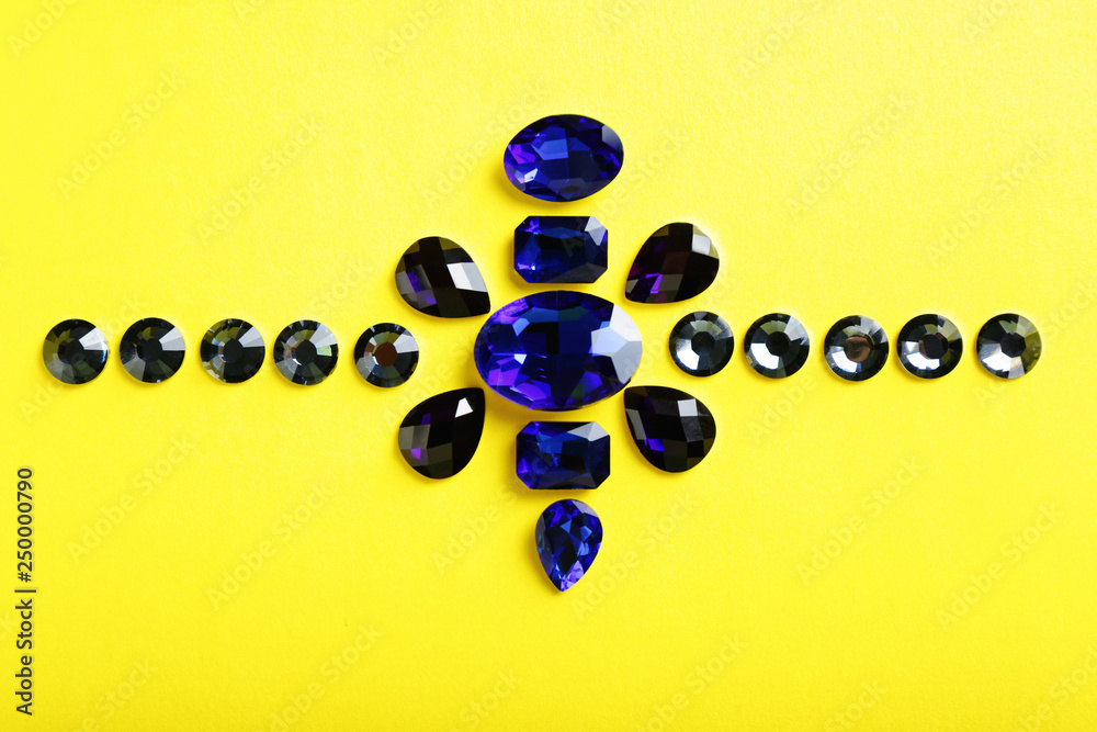 Composition with precious stones for jewellery on color background