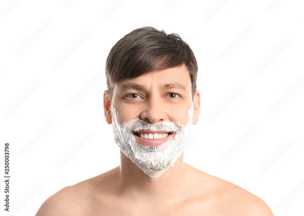 Handsome man with shaving foam on his face against white background