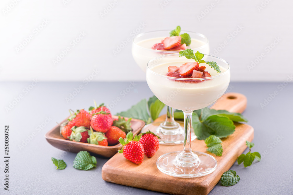 Delicous and nutritious double color (colour) strawberry desserts with mint and diced sarcocarp topp