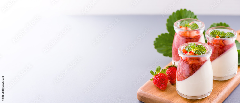 Delicous and nutritious double color (colour) strawberry desserts with mint and diced sarcocarp topp