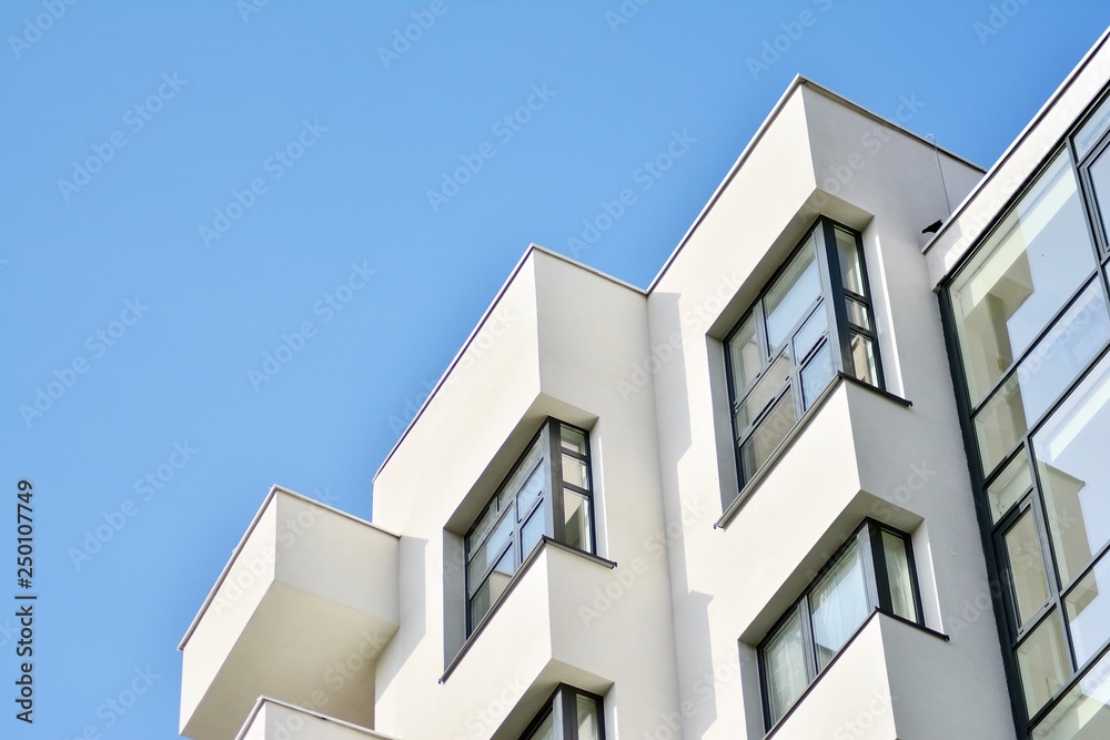 Modern white building with balcony on a blue sky