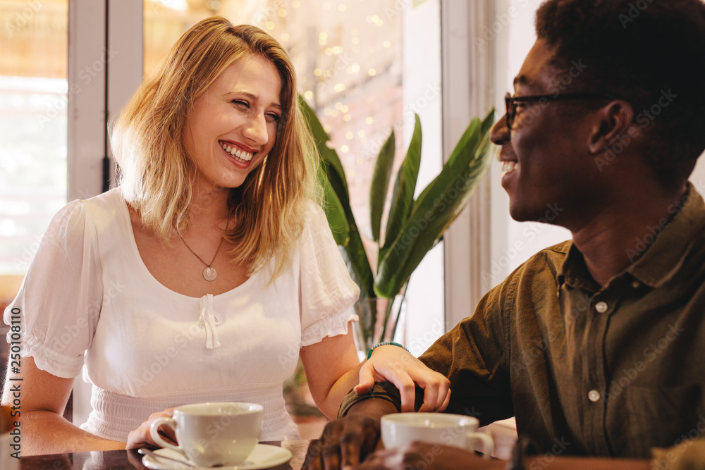 Smiling woman meeting her friend at a coffee shop