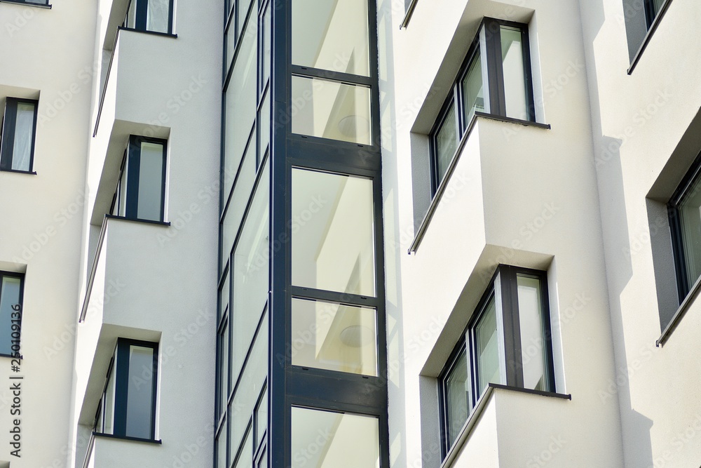 Modern white building with balcony on a blue sky