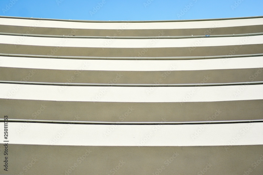 Modern white building with balcony on a blue sky