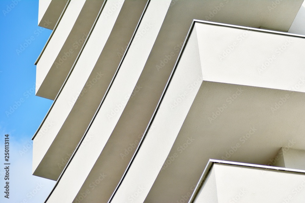 Modern white building with balcony on a blue sky